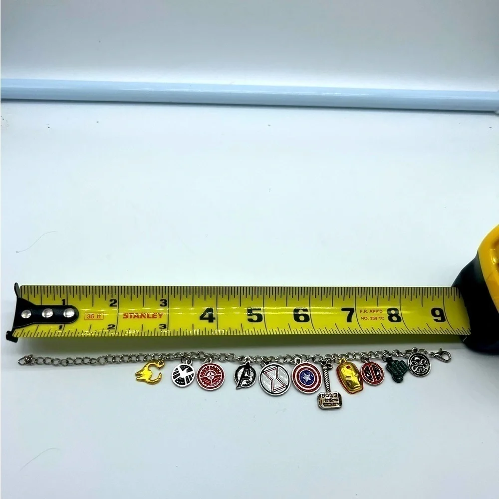 AVENGERS character charm bracelet featuring Thor’s hammer and other symbols